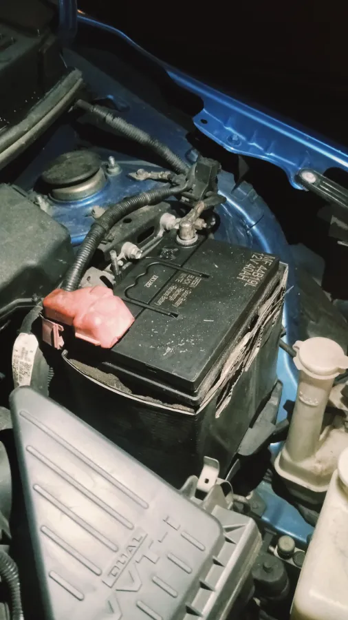 Newly fitted MF 44B19L 12V 40AH car battery in the engine bay of a blue car