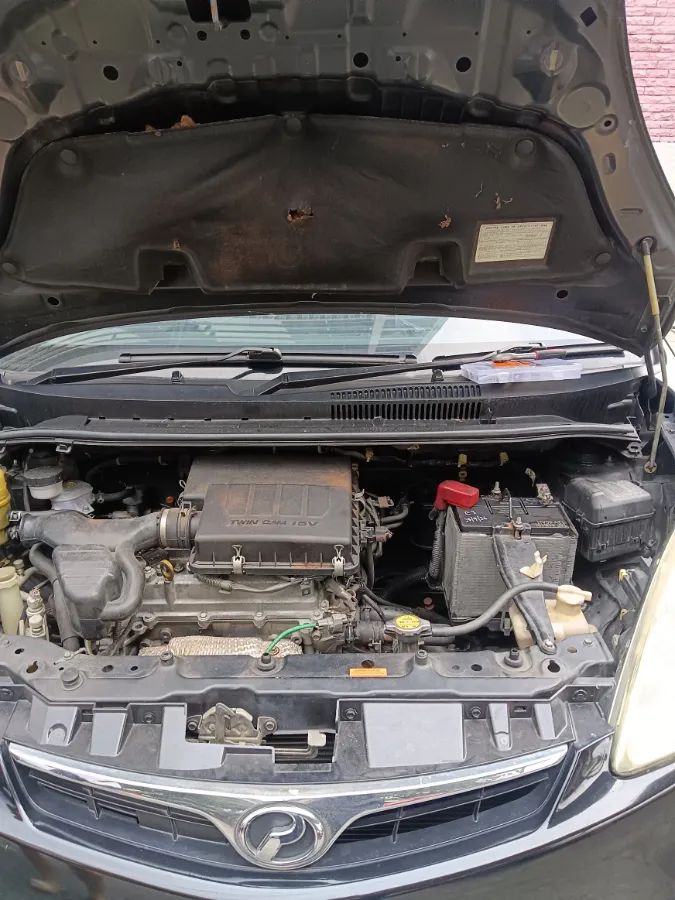 Perodua engine bay with the bonnet raised after an on-site car battery replacement
